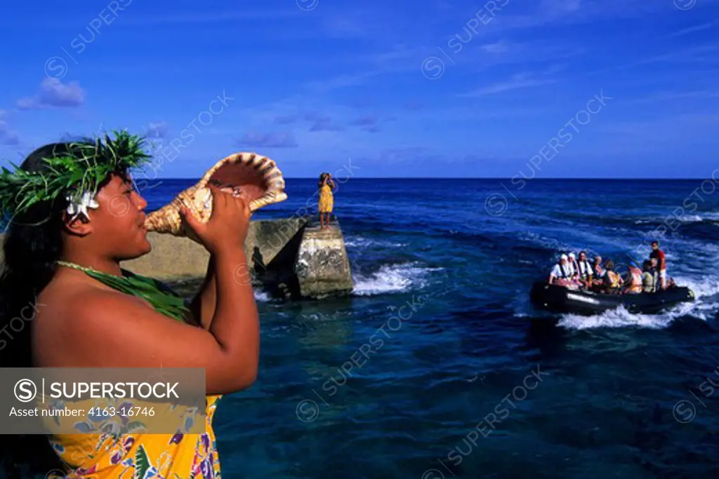 COOK ISLANDS, ATIU ISLAND, GIRL BLOWING INTO SEASHELL (HORN), GREETING TOURISTS IN ZODIAC