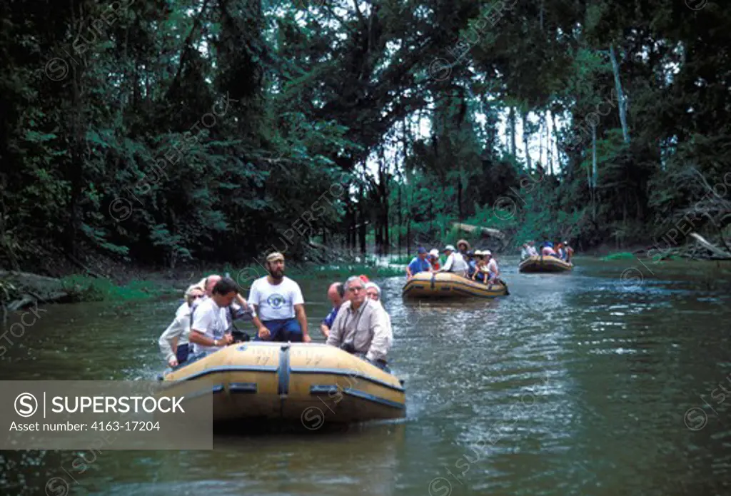 AMAZON, BRAZIL, TOURISTS ON RUBBER BOAT EXCURSION ON INNER TRIBUTORY