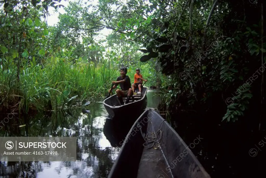 ECUADOR, AMAZON BASIN, NEAR COCA, RAIN FOREST, LOCAL INDIAN MEN IN CANOE