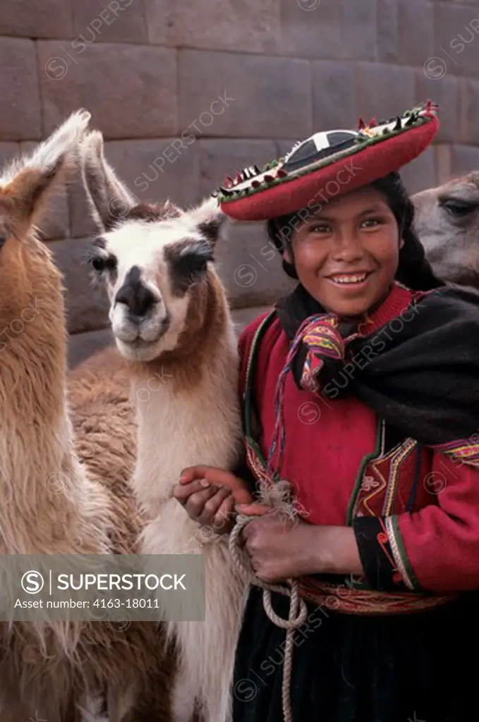 PERU, CUZCO, LOCAL WOMAN WITH LLAMAS