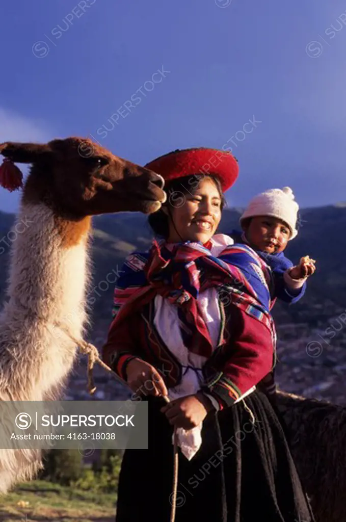 PERU, NEAR CUZCO, QUECHUA WOMAN WITH LLAMA IN EVENING LIGHT