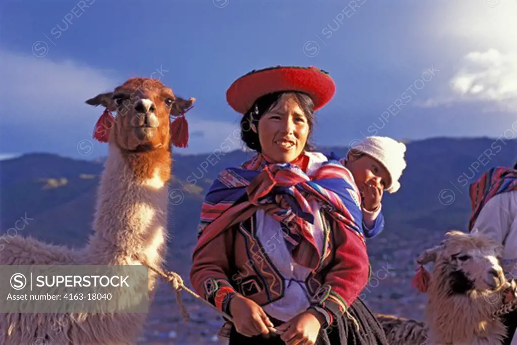 PERU, NEAR CUZCO, QUECHUA WOMAN WITH LLAMA IN EVENING LIGHT