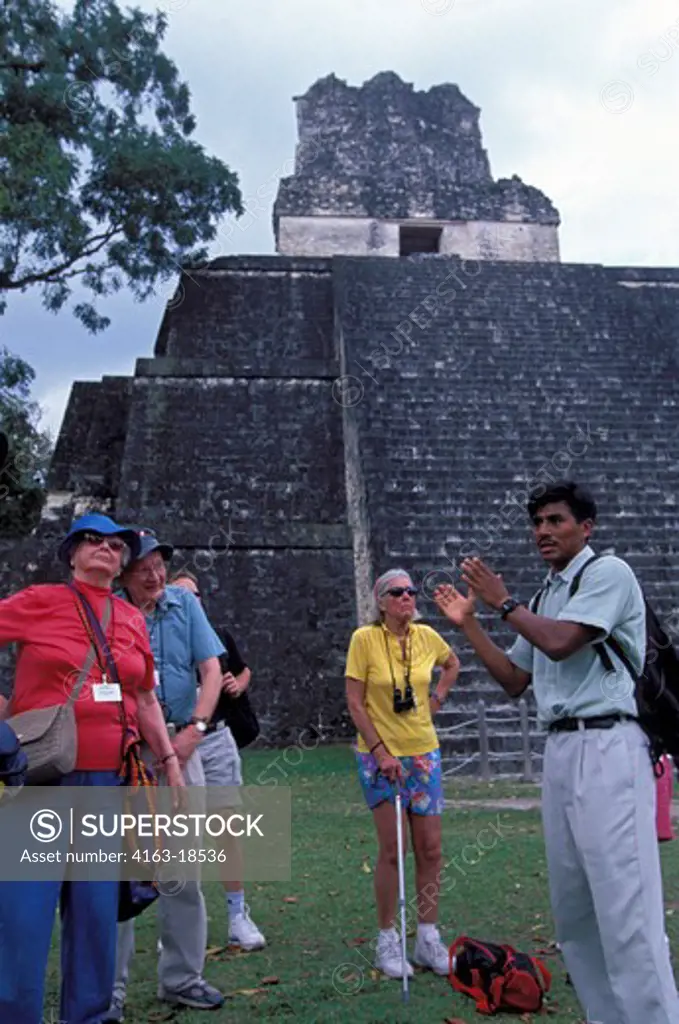 GUATEMALA, TIKAL, GRAND PLAZA, TOUR GROUP, TEMPLE II IN BACKGROUND
