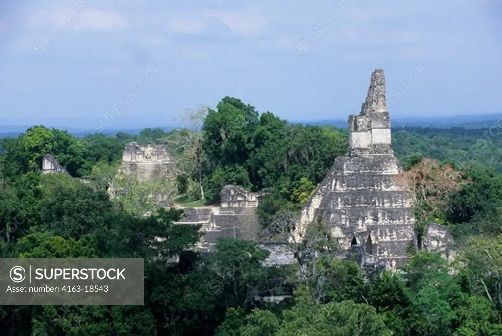 GUATEMALA, TIKAL, VIEW OF GRAND PLAZA, TEMPLE I, AND RAIN FOREST FROM TEMPLE V