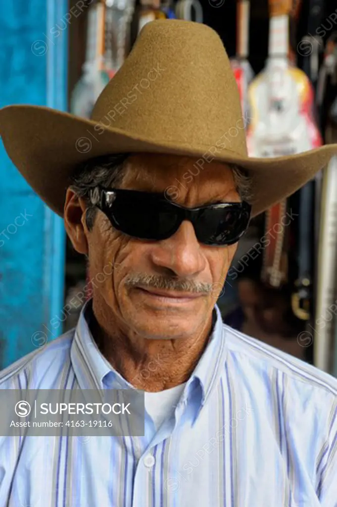 COSTA RICA, TOWN OF UPALA, STREET SCENE, BUS STATION, PORTRAIT OF MAN WITH COWBOY HAT