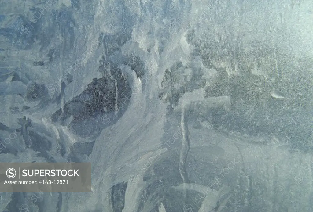 WINTER, ICE CRYSTALS PATTERNED ON FROSTED GLASS