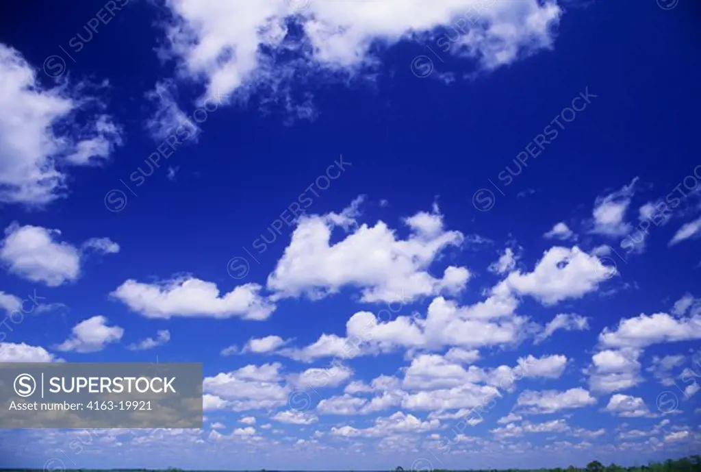 FLUFFY WHITE CLOUDS WITH BLUE SKY IN BACKGROUND