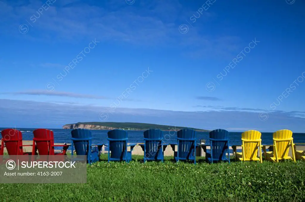 CANADA, QUEBEC, GASPE, PERCE, COLORFUL SUN CHAIRS ON LAWN