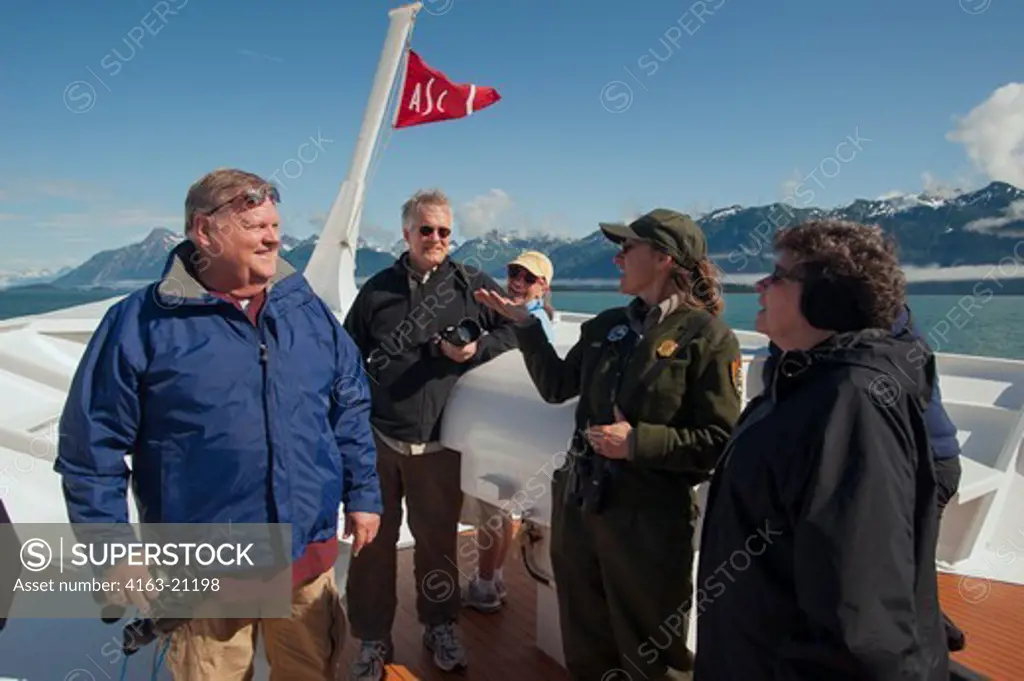 Passengers on cruise ship Safari Endeavour in Glacier Bay National Park, Alaska talking to park ranger