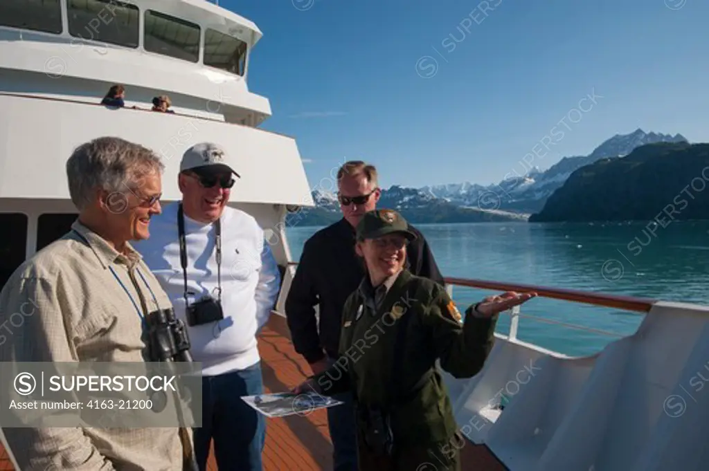Passengers on cruise ship Safari Endeavour in Glacier Bay National Park, Alaska talking to park ranger