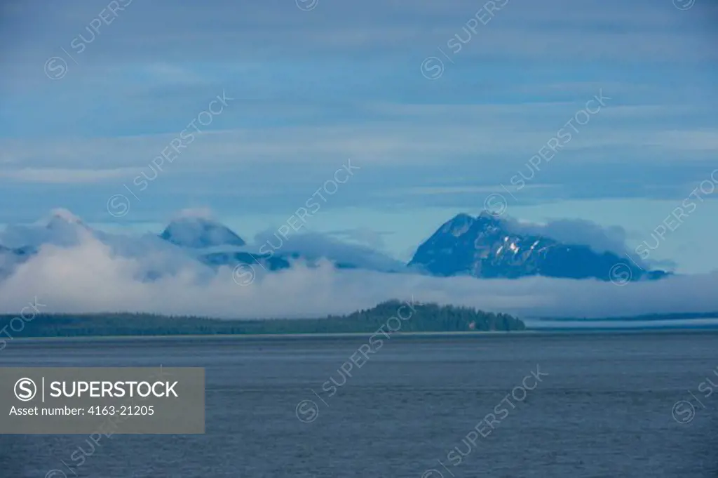 View of mountains with fog clearing at Sitakaday Narrows near Bartlett Cove, Glacier Bay National Park, Alaska