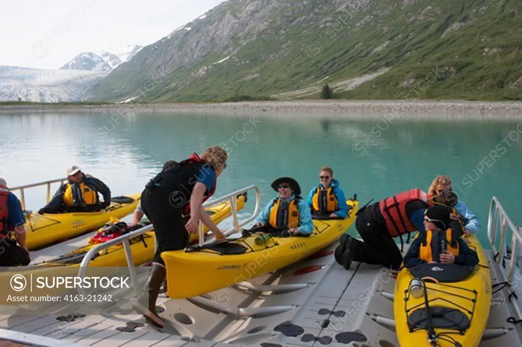 People getting into sea kayaks on loading dock of cruise ship Safari Endeavour near Reid Glacier in Glacier Bay National Park, Alaska, USA