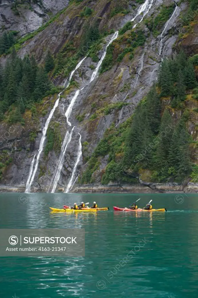 People sea kayaking in front of waterfall at Fords Terror, Endicott Arm, Tongass National Forest, Alaska, USA