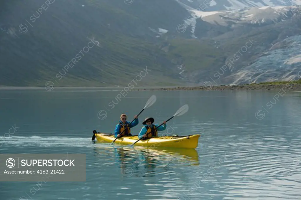 People sea kayaking near Reid Glacier in Glacier Bay National Park, Alaska, USA