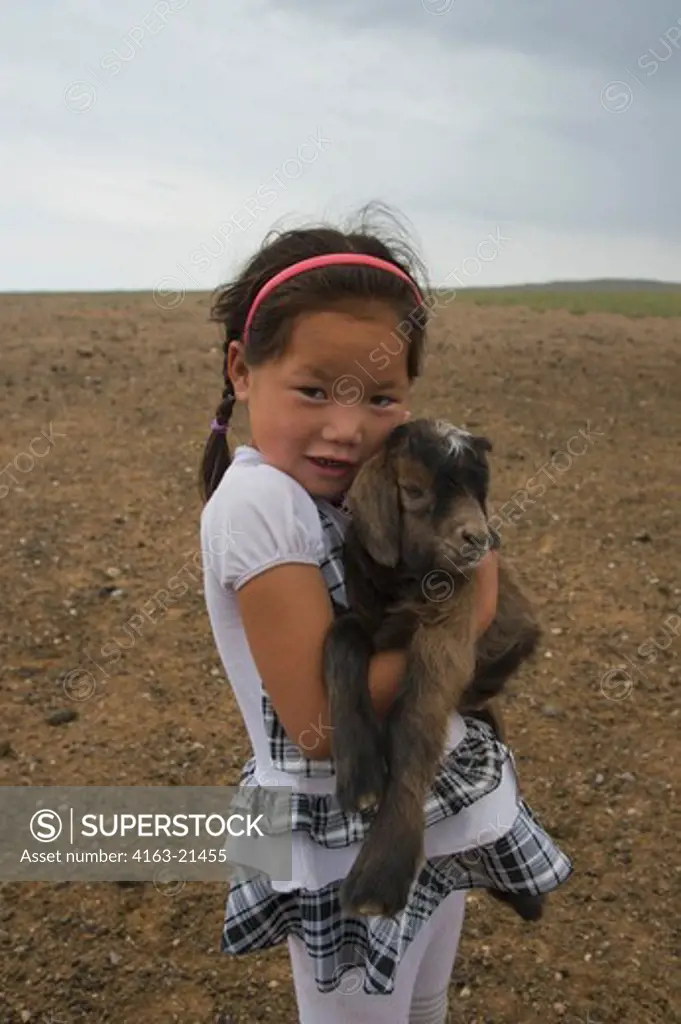 Mongolian Girl With Baby Goat At Khongoryn Els Sand Dunes In The Gobi Desert, Mongol