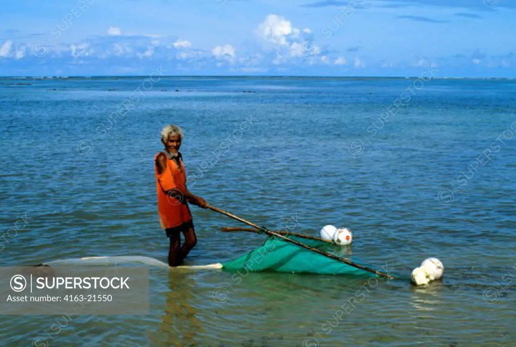 INDONESIA, SAWU (SEBA) ISLAND FISHERMAN SCOOPING NET OVER BOTTOM IN SHALLOW WATER