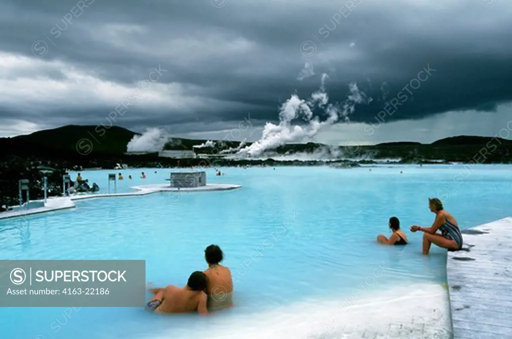 Iceland,Near Reykjavik,Blue Lagoon Thermal Area, Spa,People In Pool,Power Station In Background