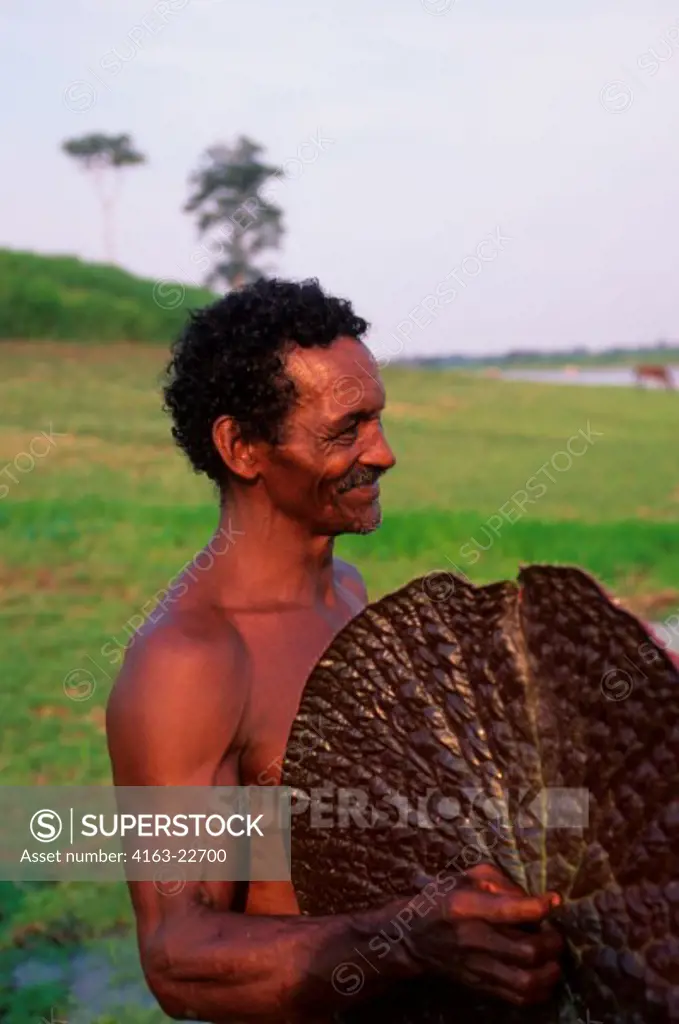 Brazil, Amazon River, Rio Balaio, Local Man (Cabocolo), Victoria Amazonica (Giant Waterlily)