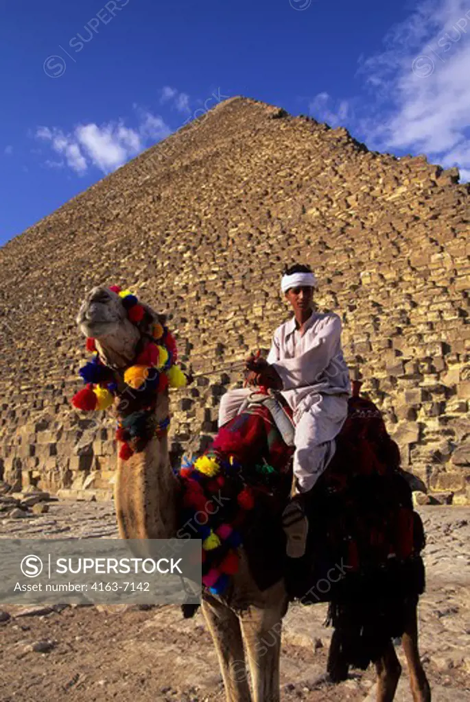 EGYPT, CAIRO, GIZA, CHEOPS PYRAMID WITH LOCAL MAN ON CAMEL IN FOREGROUND