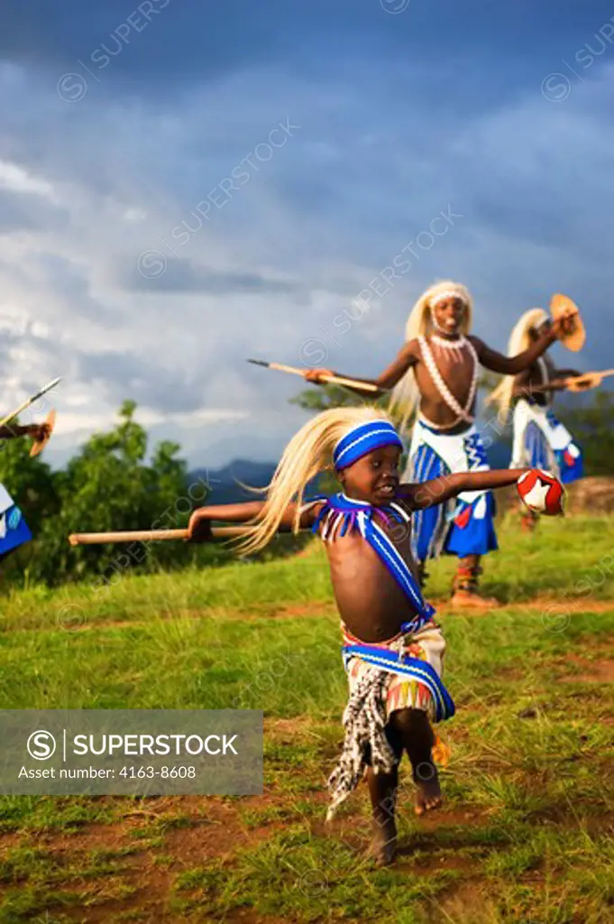 RWANDA, VIRUNGA AREA, LOCAL DANCE GROUP PERFORMING TRADITIONAL DANCES, BOY DANCER