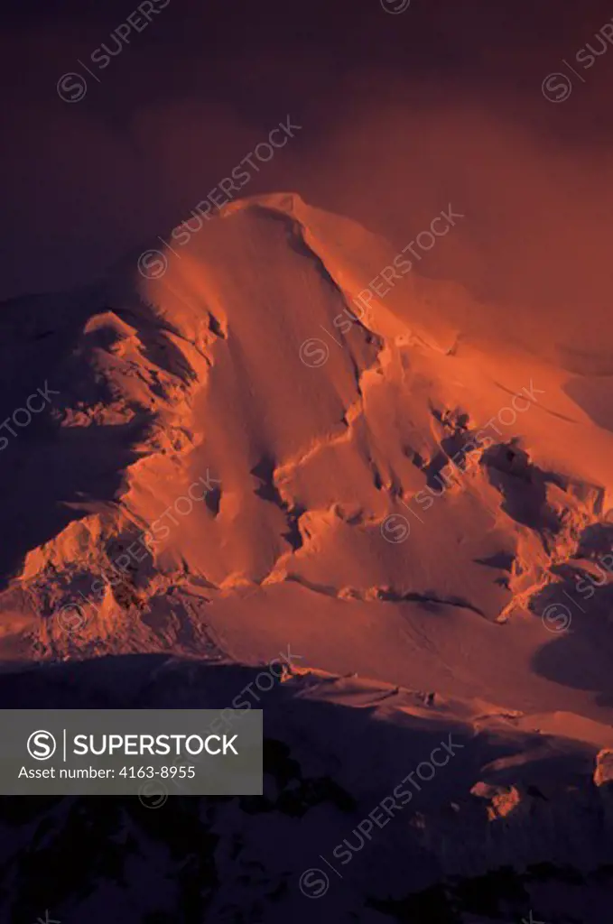ANTARCTIC PENINSULA AREA, MIDNIGHT SUNLIGHT ON GLACIER COVERED MOUNTAIN