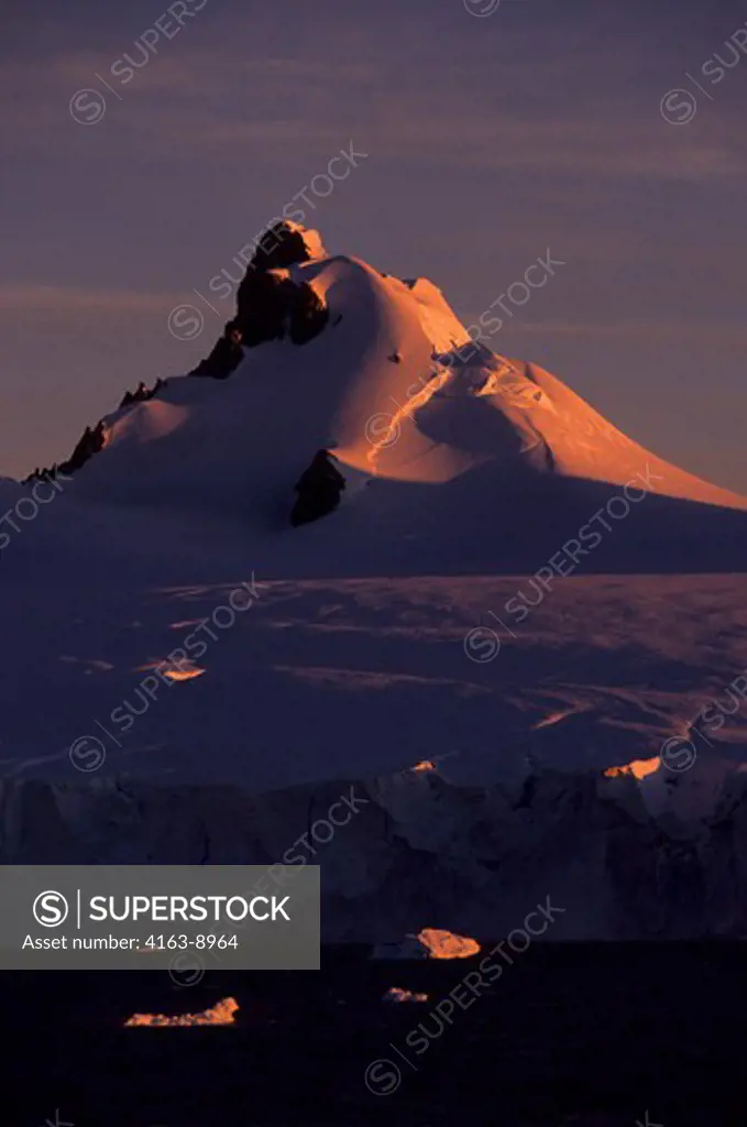 ANTARCTIC PENINSULA AREA, GLACIER COVERED MOUNTAIN IN MIDNIGHT SUNLIGHT