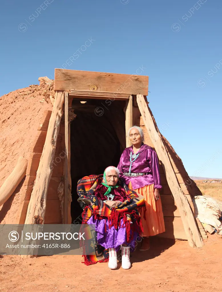 Mother and Daughter Traditional Navajo Women Posing Outside a Traditional Hogan