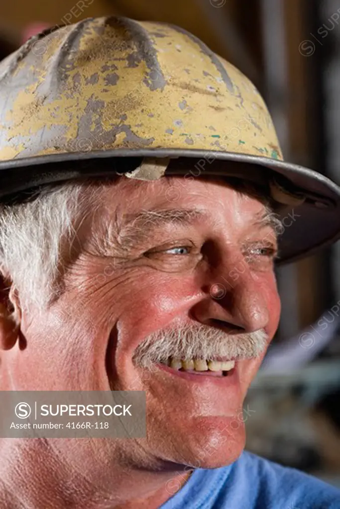 Close-up of senior man wearing hard hat