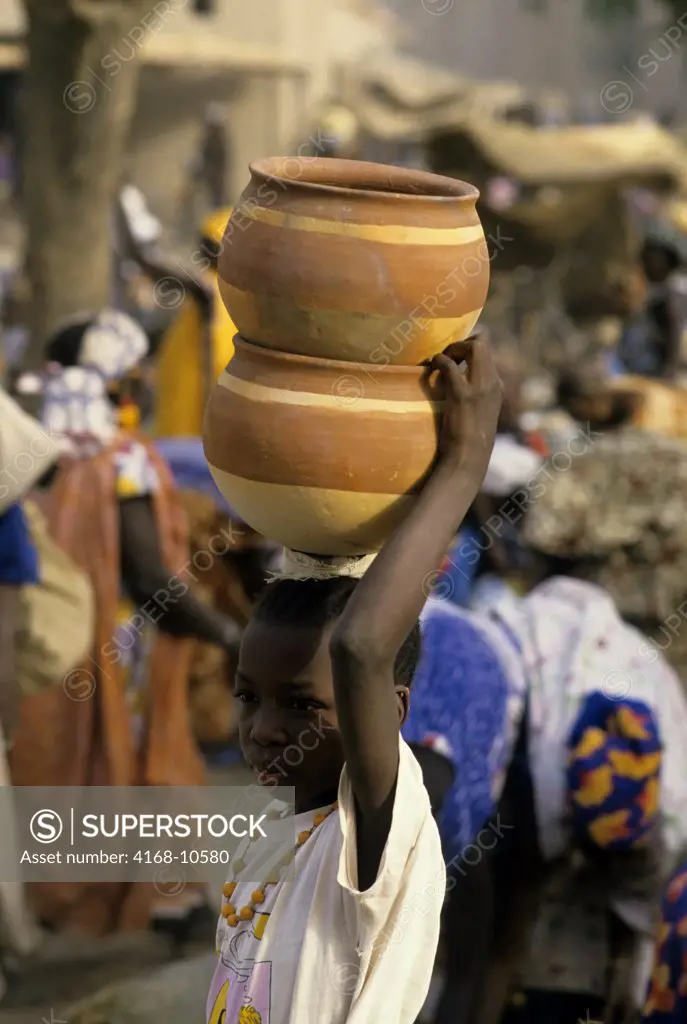 Mali, Djenne, Weekly Market, Market Scene, Local Girl Carrying Clay Pots On Her Head