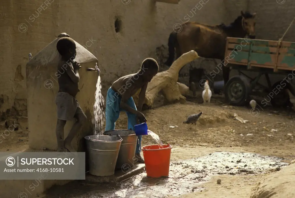 Mali, Djenne, Street Scene Boys Getting Water From Well