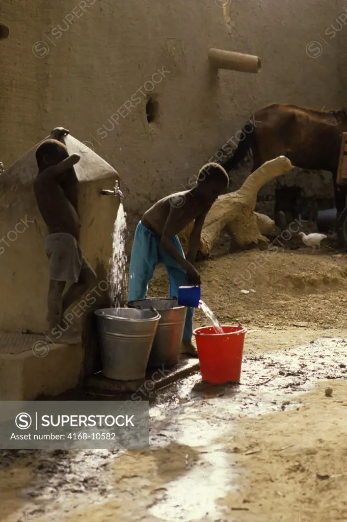 Mali, Djenne, Street Scene Boys Getting Water From Well
