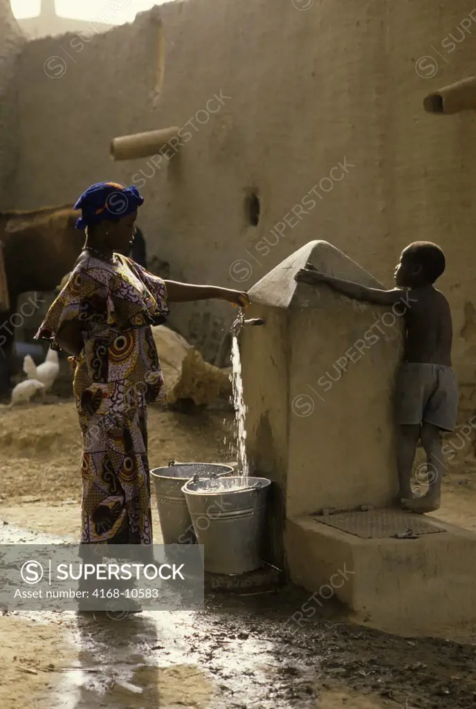 Mali, Djenne, Street Scene Girl Getting Water From Well