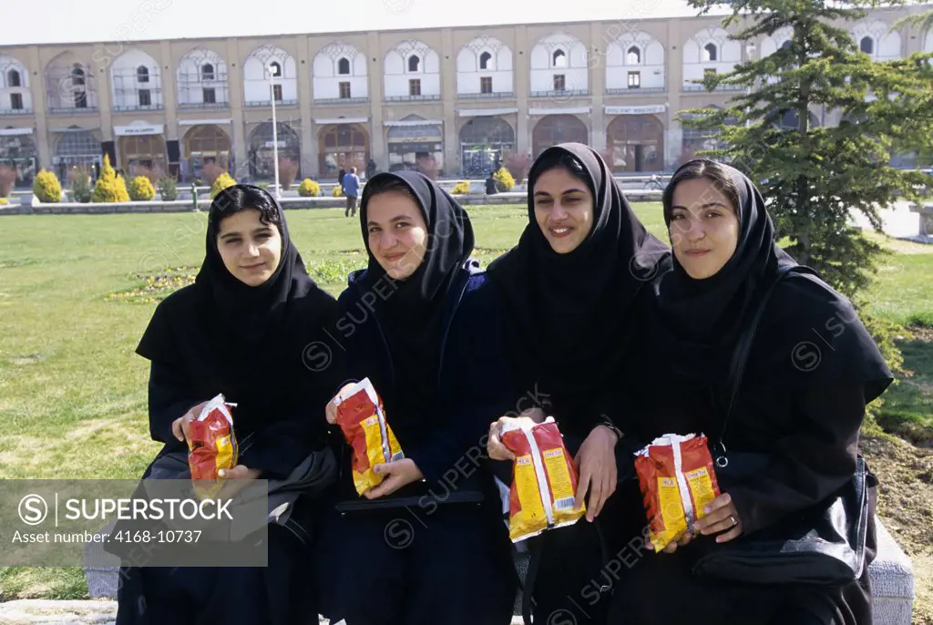 Iran, Esfahan, Eman Khomeni Square, (Royal Square), Female Students Eating Chips