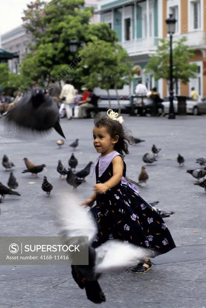 Puerto Rico, San Juan, Plaza De Armas, Local Girl Chasing Pigeons
