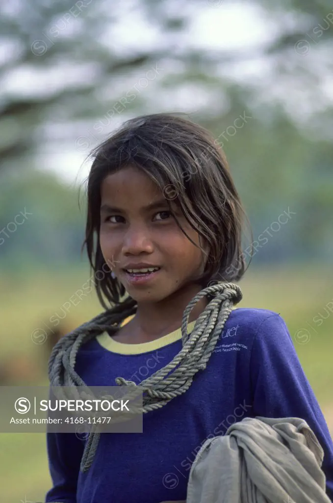 Cambodia, Angkor, Angkor Thom, Portrait Of Local Girl Watching Livestock