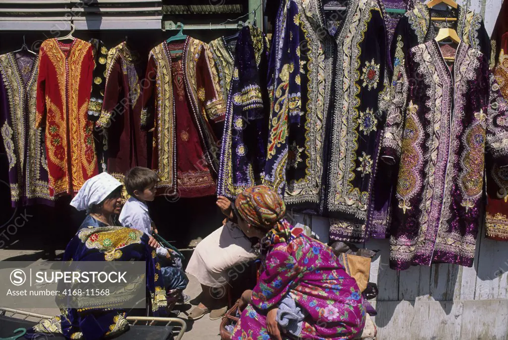 Uzbekistan, Bukhara, Market Scene With Women Selling Embroidered Dresses