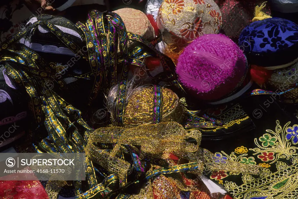 Uzbekistan, Bukhara, Market Scene With Embroidered Silk Hats And Fabrics