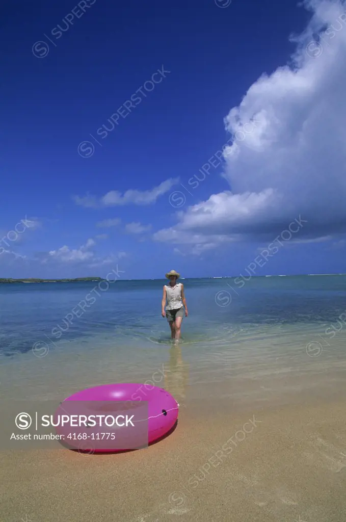 Puerto Rico, Near Fajardo Beach, Pink Innertube With Tourist In Background
