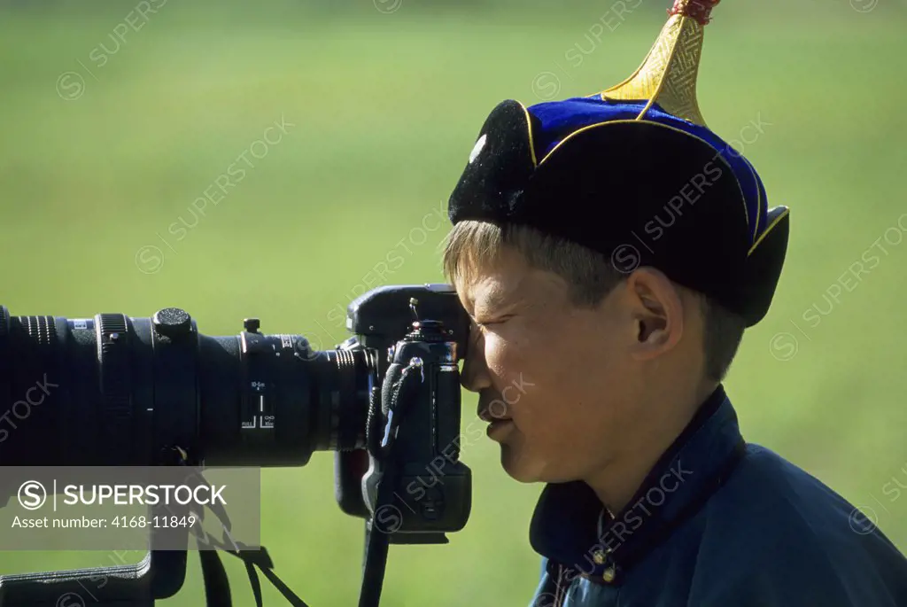 Mongolia, Ulaanbaatar, Naadam Festival, Boy In Traditional Clothing Looking Through Camera