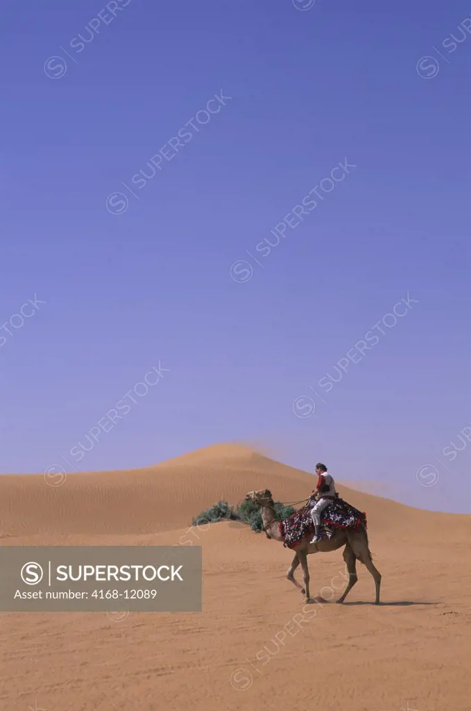 Saudi Arabia, Near Riyadh, Tourist On Camel In Desert