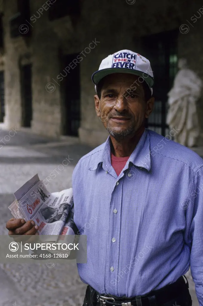 Cuba, Old Havana, Street Scene, Man Selling Newspapers