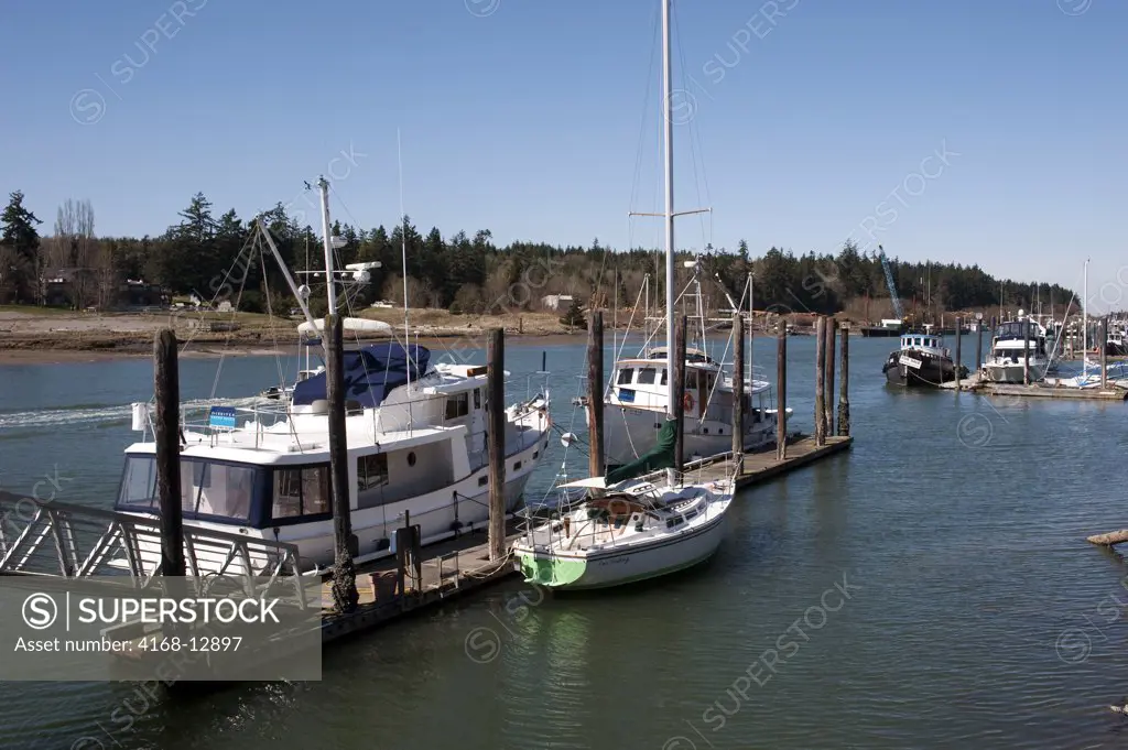 USA,  Washington State, Skagit Valley, La Conner, View Of Canal With Boat Dock, Powerboat And Sailboat