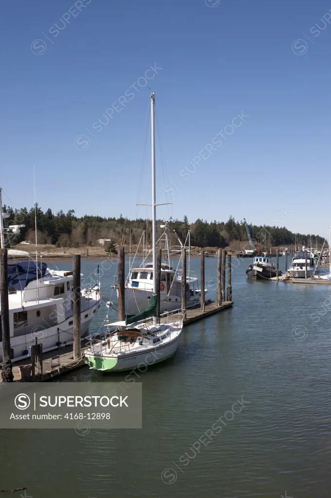 USA,  Washington State, Skagit Valley, La Conner, View Of Canal With Boat Dock, Powerboat And Sailboat