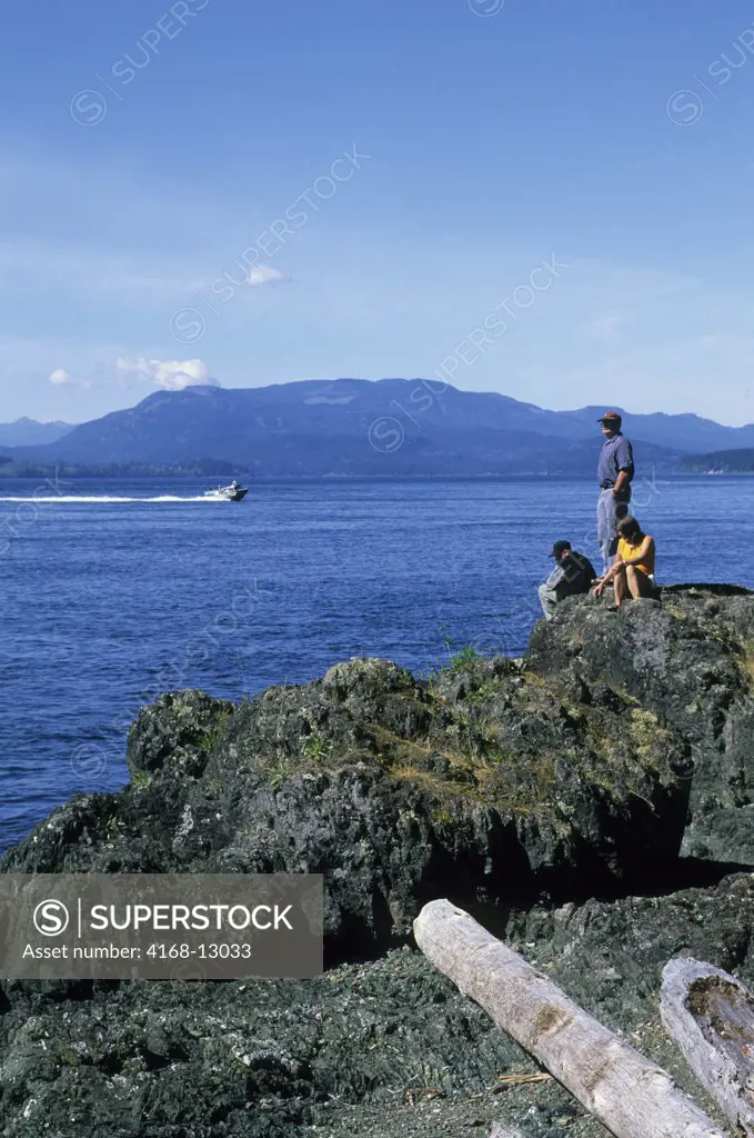 Canada, British Columbia, Near Vancouver Island, Quadra Island, People On Rocky Coastline