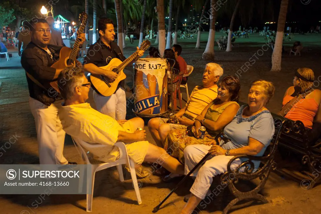 People Enjoying Musicians On Beach Promenade At Night Of El Rodadero, Santa Marta, Colombia