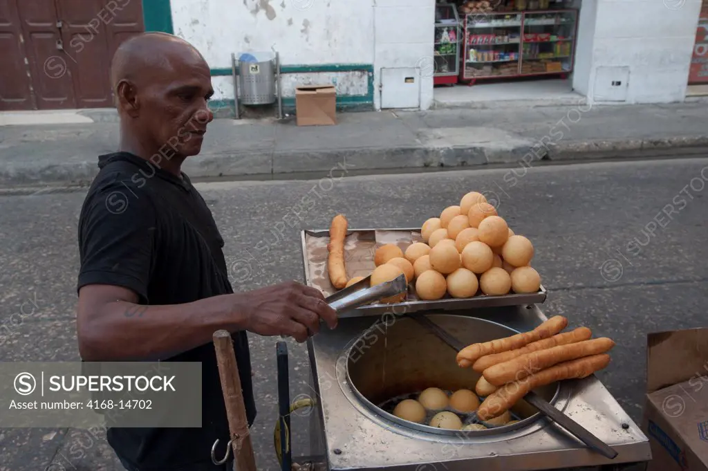Street Vendor Preparing Fried Breakfast Food In The Streets Of Cartagena, Colombia