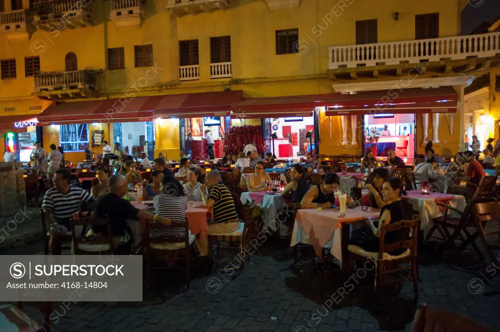 Outdoor Restaurants At Night On Plaza Santo Domingo In Cartagena, Colombia, A Walled City And Unesco World Heritage Site