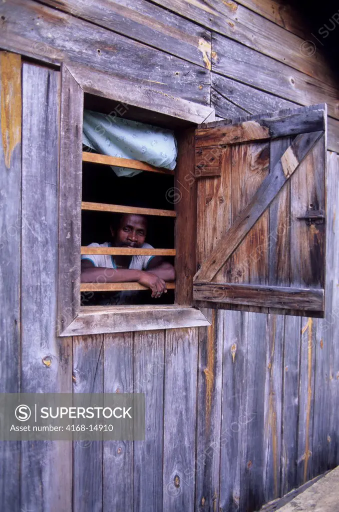 Madagascar, Near Moramanga, Mandraka, Man Looking Out Of Hut Window