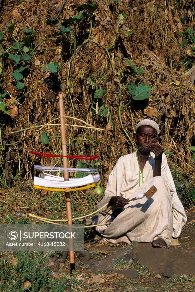 Ethiopia, Near Bahar Dar, Village Scene, Man Spinning Cotton