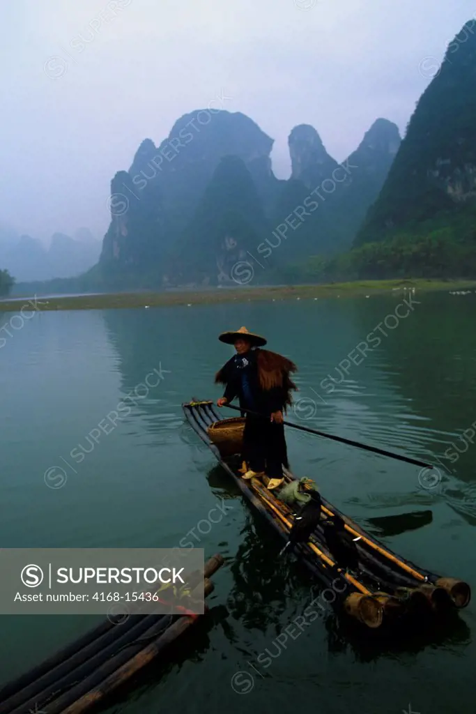 China, Guangxi Province, Near Guilin, Xing Ping, Li River, Rain, Fisherman On Bamboo Raft, Cormorants